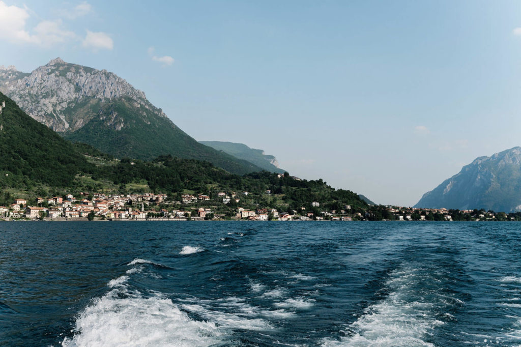 Blue ocean with mountains and houses on the background